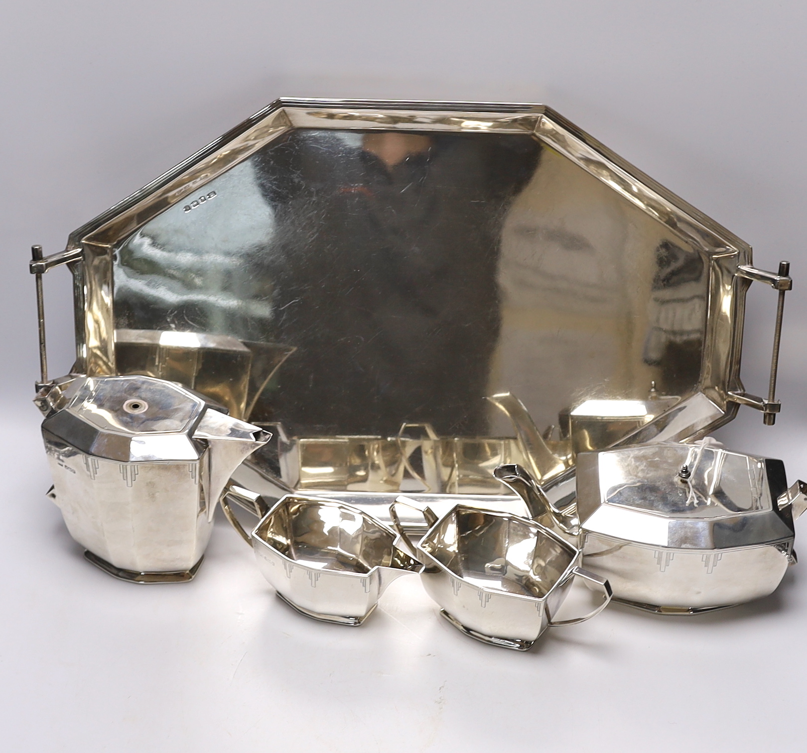 A George V Art Deco silver four piece tea set with tea tray, by Viners Ltd, Sheffield, 1934/36, 114.5oz. (lacking handles)